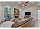 Cozy living room with brick fireplace, coffered ceilings, and bright windows at 5760 Windjammer Pt, Cumming, GA 30041