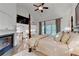 Spacious main bedroom with vaulted ceiling, fireplace, and large windows at 5760 Windjammer Pt, Cumming, GA 30041