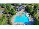 Aerial view of pool area with a clubhouse and playground nearby at 5760 Windjammer Pt, Cumming, GA 30041