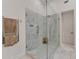 Large glass shower with marble detail and heated towel rack in bathroom at 5760 Windjammer Pt, Cumming, GA 30041