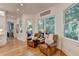 Cozy sitting area featuring windows to the exterior and comfortable leather armchairs and side table at 5760 Windjammer Pt, Cumming, GA 30041