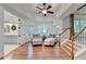 Comfortable sitting area with plush armchairs, ottomans, and a view of the outdoors near the entry to the bathroom at 5760 Windjammer Pt, Cumming, GA 30041