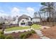 Home's backyard with tiered stone patio, wooden deck, manicured lawn, and privacy fencing at 9811 Spyglass Dr, Villa Rica, GA 30180