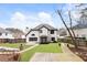 Spacious backyard featuring a stone patio, wooden deck, manicured lawn, and privacy fence at 9811 Spyglass Dr, Villa Rica, GA 30180