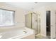 Bright bathroom with tub, shower, and neutral-toned finishes at 9811 Spyglass Dr, Villa Rica, GA 30180