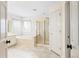 Bright bathroom featuring tile floors, gold shower, and bathtub at 9811 Spyglass Dr, Villa Rica, GA 30180