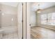 Bathroom with tub and tile, leading to bright, airy room at 9811 Spyglass Dr, Villa Rica, GA 30180