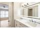 Bathroom with dual sinks, marble countertops, and modern lighting at 9811 Spyglass Dr, Villa Rica, GA 30180