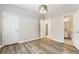 Spacious bedroom showcasing hardwood floors, modern lighting, and neutral paint at 9811 Spyglass Dr, Villa Rica, GA 30180