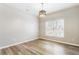 Bright dining room featuring laminate floors, modern lighting, and large window at 9811 Spyglass Dr, Villa Rica, GA 30180