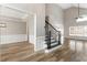 Inviting foyer with wainscoting, hardwood floors, and open staircase to the upper level at 9811 Spyglass Dr, Villa Rica, GA 30180