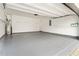 Spacious two-car garage featuring an epoxy floor, ample lighting, and plenty of room for storage at 9811 Spyglass Dr, Villa Rica, GA 30180