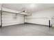 Garage interior featuring epoxy floors, high ceilings, shelving, and ample space at 9811 Spyglass Dr, Villa Rica, GA 30180