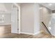 Open hallway with laminate floors leading into other rooms with natural light at 9811 Spyglass Dr, Villa Rica, GA 30180