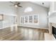 Bright living room featuring a vaulted ceiling, fireplace, and hardwood flooring at 9811 Spyglass Dr, Villa Rica, GA 30180