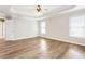 Spacious main bedroom featuring hardwood floors, ceiling fan, and natural light at 9811 Spyglass Dr, Villa Rica, GA 30180