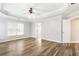 Bright main bedroom featuring hardwood floors, tray ceiling, and natural light at 9811 Spyglass Dr, Villa Rica, GA 30180