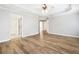 Spacious main bedroom featuring laminate floors, ceiling fan, and doorways at 9811 Spyglass Dr, Villa Rica, GA 30180