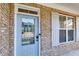 Close up of the front door showcasing the brick facade and a light blue front door at 270 Ascott Ln, Woodstock, GA 30189