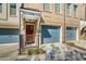 Close-up of townhome entrance with stone accents, covered porch, and blue garage doors at 278 Goodson Nw Way, Atlanta, GA 30309