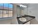 Bright bathroom featuring a vanity with a stone counter, framed mirror and modern lighting at 2822 Ward Lake Way, Ellenwood, GA 30294