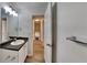 The bathroom vanity features stone counters, a framed mirror, and modern lighting at 2822 Ward Lake Way, Ellenwood, GA 30294