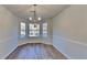 Bright dining area features three windows for great natural light and a stylish modern chandelier at 2822 Ward Lake Way, Ellenwood, GA 30294