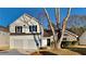 Charming two-story home boasts a manicured lawn, two-car garage, and inviting stone accents at 2822 Ward Lake Way, Ellenwood, GA 30294