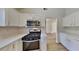 Modern kitchen with stainless steel appliances, white cabinets, and ample counter space at 2822 Ward Lake Way, Ellenwood, GA 30294