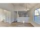 This spacious living room showcases a modern chandelier and beautiful bright windows at 2822 Ward Lake Way, Ellenwood, GA 30294