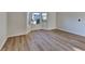 This living room features beautiful new floors and abundant natural light from bay windows at 2822 Ward Lake Way, Ellenwood, GA 30294