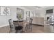 Charming breakfast nook with round table and black chairs adjacent to the living room at 3897 Lockaby Way, Lawrenceville, GA 30044