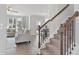 Cozy living room with hardwood floors, neutral furniture, staircase, and lots of natural light at 3897 Lockaby Way, Lawrenceville, GA 30044