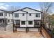 Newly constructed townhomes feature white siding, black trim, and private balconies at 971 Boulevard Se # B, Atlanta, GA 30312