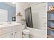 Clean bathroom featuring a tub and shower combination, vanity, and linen storage at 238 Gallant Fox Way, Acworth, GA 30102