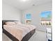 A well lit bedroom with two windows and a dark-colored bed frame with storage drawers underneath at 238 Gallant Fox Way, Acworth, GA 30102