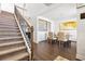 Bright dining room with modern chandelier, a large picture window and staircase access at 238 Gallant Fox Way, Acworth, GA 30102