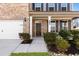 Inviting front entrance with black door, manicured landscaping and an attached garage at 238 Gallant Fox Way, Acworth, GA 30102