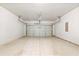 Empty two-car garage with concrete floor, white walls, and garage door opener at 238 Gallant Fox Way, Acworth, GA 30102