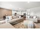 Open-concept living room with hardwood floors leading to the kitchen with a breakfast bar at 238 Gallant Fox Way, Acworth, GA 30102