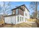 Rear exterior showcasing a fenced-in yard, modern siding, and large casement windows at 662 S Grand Nw Ave, Atlanta, GA 30318