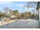 View of fenced backyard from the balcony, complete with gray tiled flooring and iron railings at 662 S Grand Nw Ave, Atlanta, GA 30318