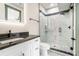 Modern bathroom vanity and shower area featuring black countertop, stylish fixtures, and glass shower door at 662 S Grand Nw Ave, Atlanta, GA 30318