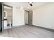 Bedroom with neutral walls, light gray flooring, and a view into the bathroom at 662 S Grand Nw Ave, Atlanta, GA 30318