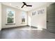 Bedroom features hardwood floors, a modern ceiling fan, and multiple windows with natural light and a view at 662 S Grand Nw Ave, Atlanta, GA 30318