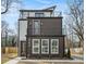 Modern three-story home with balconies, mixed siding, and manicured landscaping at 662 S Grand Nw Ave, Atlanta, GA 30318