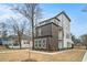 Exterior view of a modern three-story home with balconies and manicured landscaping at 662 S Grand Nw Ave, Atlanta, GA 30318