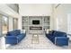 Spacious living room featuring a fireplace, built-in shelving and stylish blue couches at 662 S Grand Nw Ave, Atlanta, GA 30318