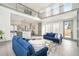 Open-concept living room with a view of the modern kitchen and a soaring two-story ceiling at 662 S Grand Nw Ave, Atlanta, GA 30318