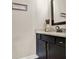 Bathroom with granite countertops, black cabinetry, and a decorative mirror at 71 Presley Farm Ln, Rockmart, GA 30153